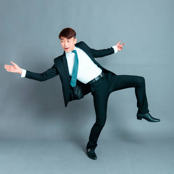 istock Happy young business man dancing in motion 1193432839