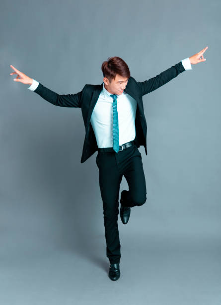 istock Happy young business man dancing in motion 1193432906