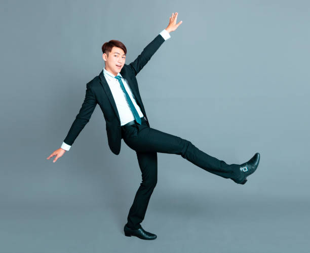 istock Happy young business man dancing in motion 1193432961