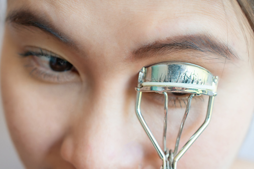 Eyelash curler is a hand-operated mechanical device for curling eyelashes for cosmetic purposes.
