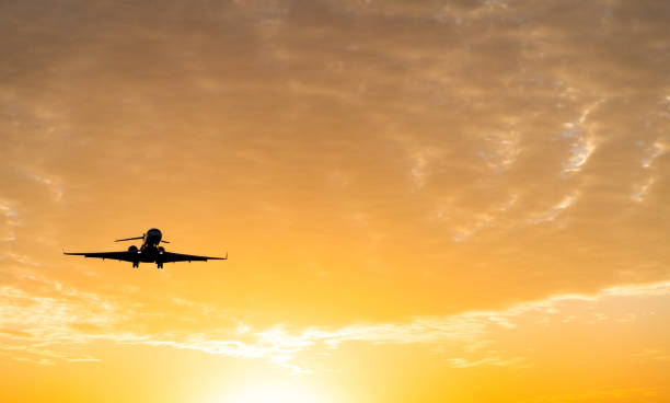 istock An airplane flying at sunset 1193439519