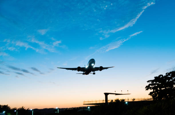 istock Airplane flying over radio antenna 1193441748