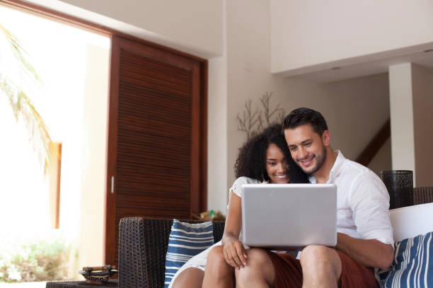 istock Couple resting on vacation is using the computer in the hotel room 1193441964