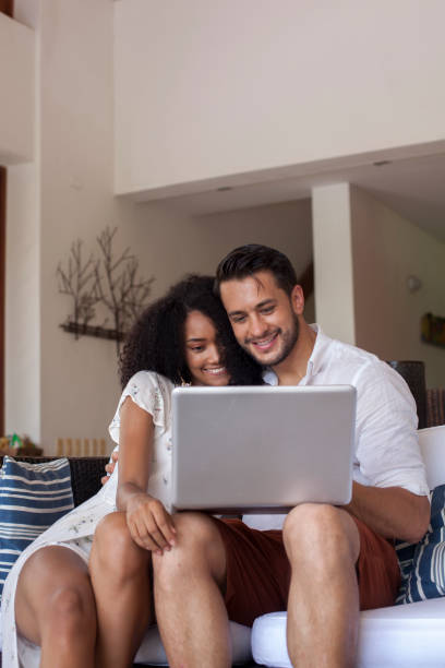 istock Couple resting on vacation is using the computer in the hotel room 1193442008