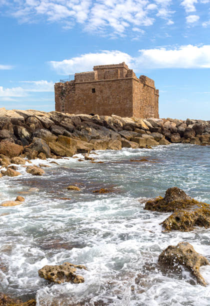 Old castle on Mediterranean sea coast. Paphos, Cyprus. Bright sunset light