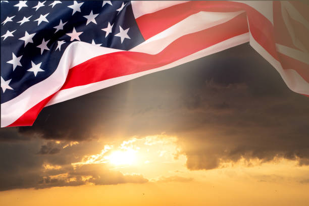 istock us flag against  orange sky background 1193442893