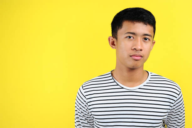 istock Teenage Asian boy with serious expression, head and shoulders 1193443830