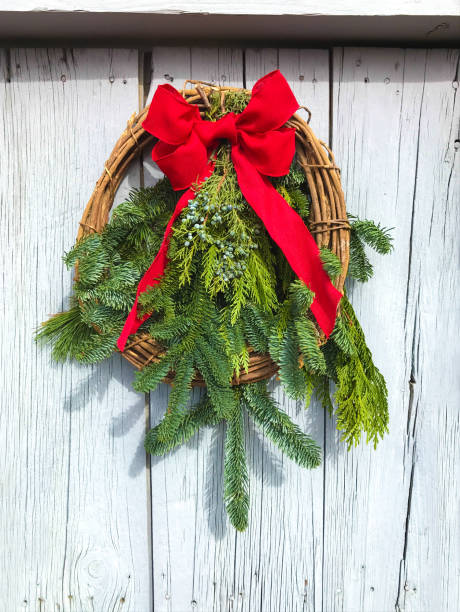 istock Green Christmas Wreath, Red Bow, Rustic Door 1193444182