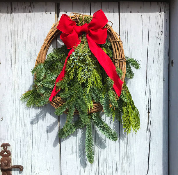 istock Green Christmas Wreath, Red Bow, Rustic Door 1193444799