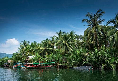 traditional jungle ferry boat at pier on tatai river in cambodia