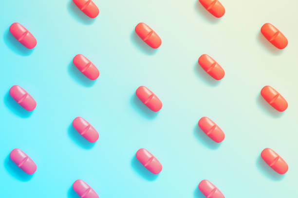 istock pattern of red pills on a colorful background. 1193445709
