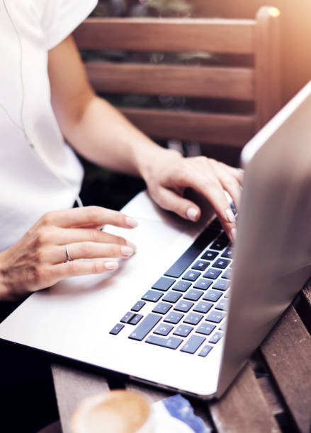 istock Young woman with laptop on summer balcony 1193449532