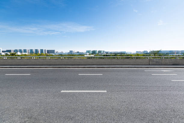 Empty asphalt road with buildings in the city Empty asphalt road with buildings in the city. empty road stock pictures, royalty-free photos & images