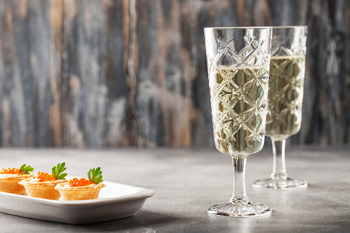 Glasses of  champagne on gray background. Festive drink. Valentins or Christmas concept.