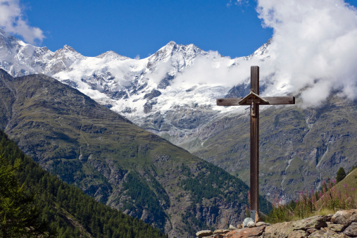 Cross in front of Weisshorn in the swiss alps