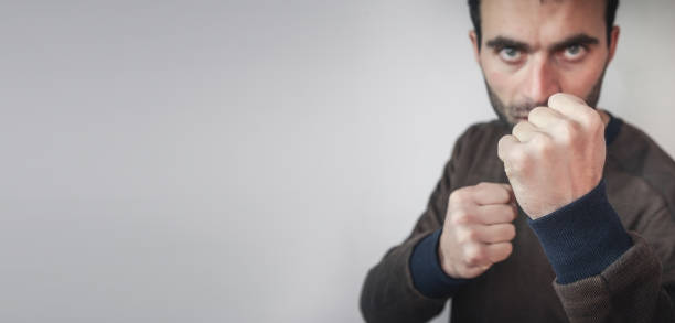 istock Caucasian aggressive man threatening with fists. 1193451504