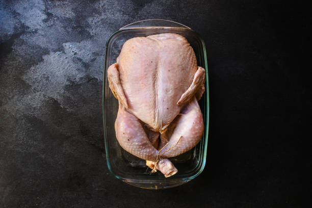 istock raw chicken in marinade (poultry, carcass meat) menu concept. food background. top view. copy space 1193452660