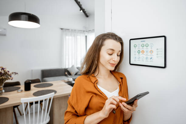 istock Woman controlling smart devices with a digital tablet at home 1193452721