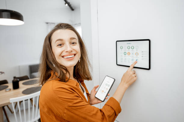 istock Woman controlling smart devices with a digital tablet at home 1193452728