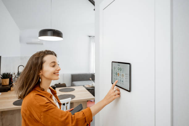 istock Woman controlling smart devices with a digital tablet at home 1193452733