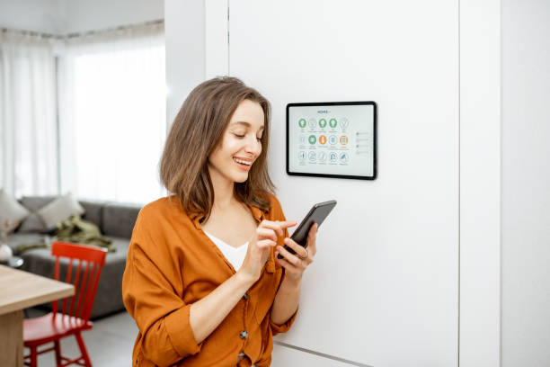 istock Woman controlling smart devices with a digital tablet at home 1193452742
