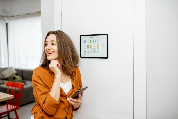 istock Woman controlling smart devices with a digital tablet at home 1193452756