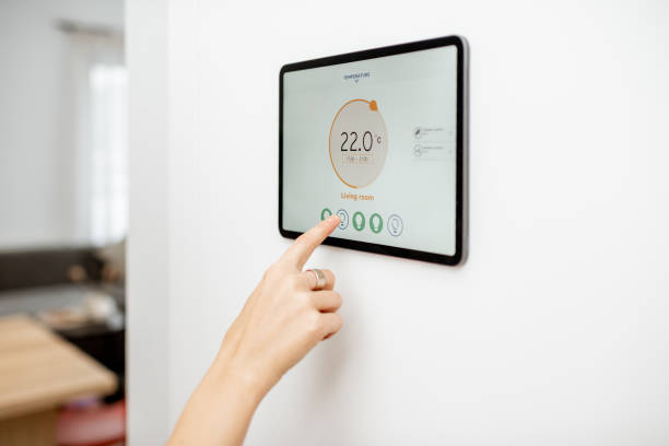 istock Woman controlling heating with a smart devices 1193452758