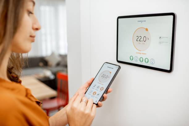 istock Woman controlling heating with a smart devices 1193452776