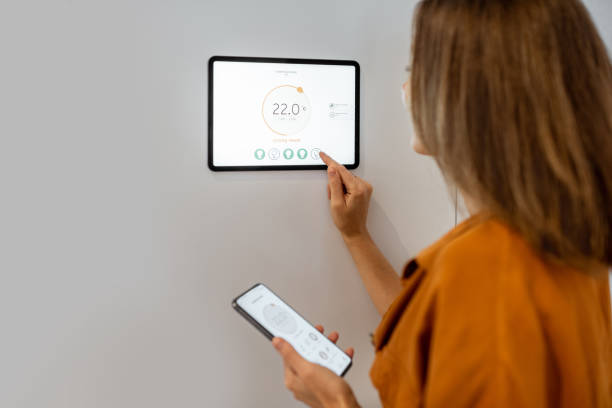 istock Woman controlling heating with a smart devices 1193452797