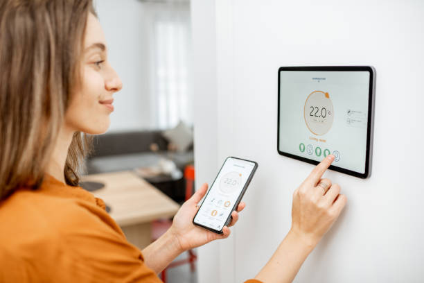 istock Woman controlling heating with a smart devices 1193452798