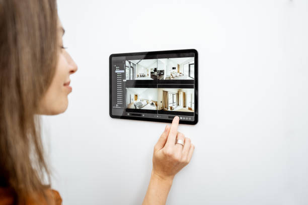 istock Woman controlling home with video cameras and digital tablet 1193452996