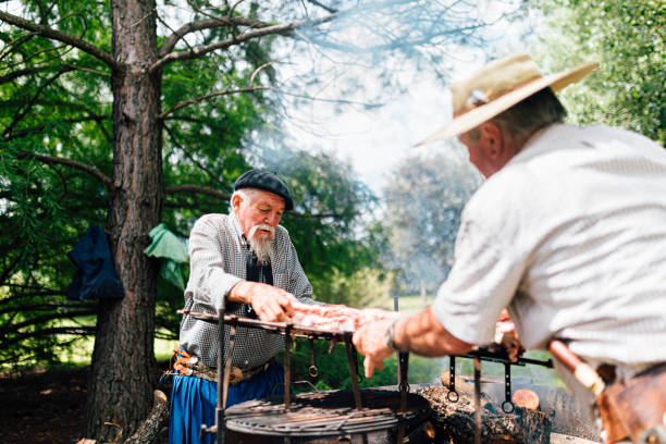istock Two senior Argentinian gauchos preparing traditional barbecue 1193454065