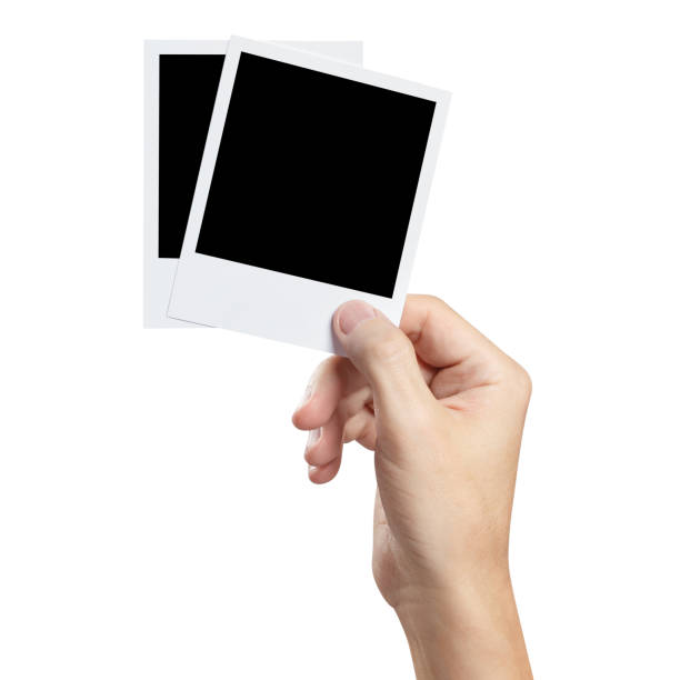 istock Hand holding photocards on white 1193454695