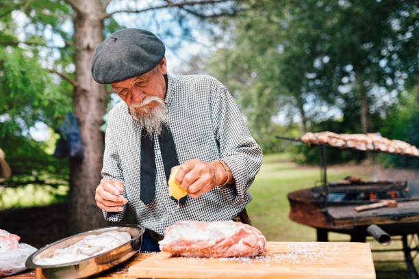 istock Senior Argentinian gaucho squeezing lemon on meat 1193454759
