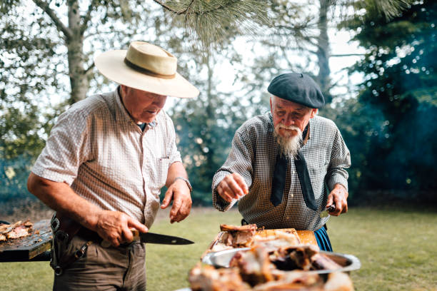 istock Two senior Argentinian gauchos preparing traditional barbecue 1193454844