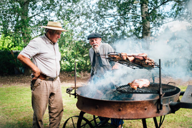 istock Two senior Argentinian gauchos preparing traditional barbecue 1193454845