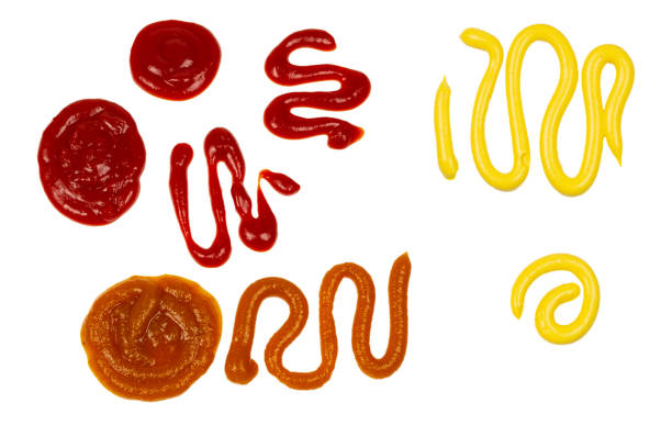 istock Ketchup and yellow sauce splashes isolated on white background. 1193456267