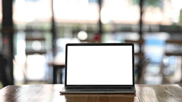 istock Mockup laptop computer on wooden table. 1193457487