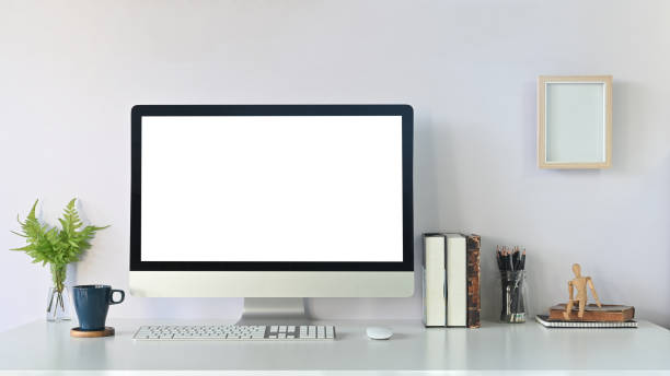 istock Comfortable workspace computer mockup, coffee, books, pencil and plant with photo frame on white desk. 1193457574