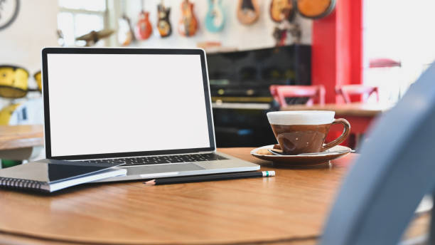 istock Mockup laptop computer, coffee, notepad and pencil on table in music house. 1193457761