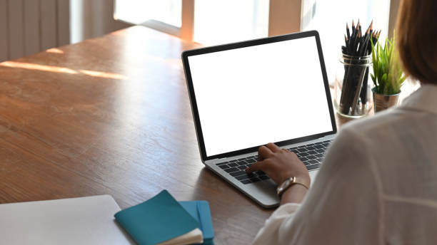 istock Close-up young woman working with laptop computer, empty screen display. 1193457801