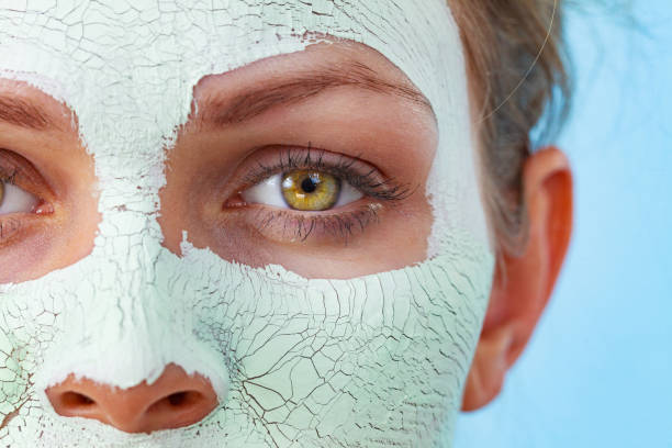 istock Girl with mud mask on face 1193458039