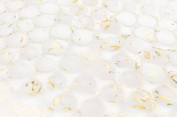 istock White soft light bubbles pattern of hydrogel balls and gold glitter as contemporary New Year abstract background. 1193461098