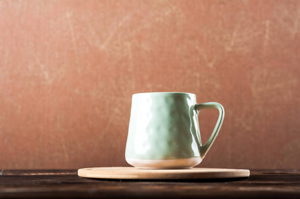 istock Clay cup on a wooden board on a dark background. 1193462120
