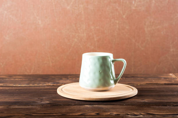 istock Clay cup on a wooden board on a dark background. 1193462124