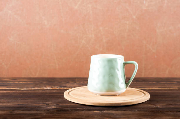 istock Clay cup on a wooden board on a dark background. 1193462129