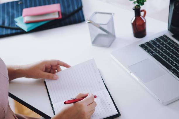 istock young woman studying while sitting at the table with laptop computer and notebook during lesson in classroom. 1193462609