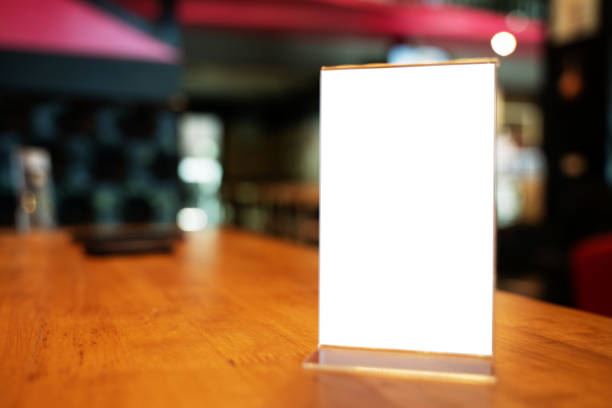 istock Mock up Menu frame standing on wood table in Bar restaurant cafe. space for text 1193464281