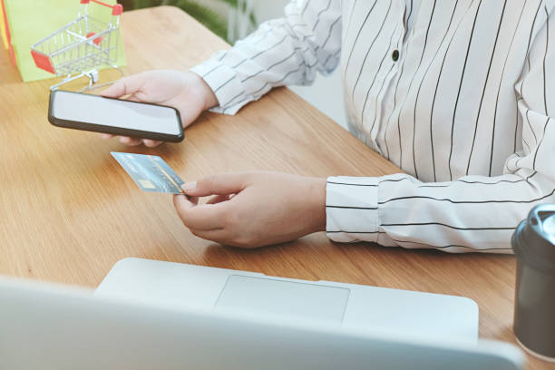 istock Woman paying with credit card online orders the Internet. and making transaction using mobile bank application. . 1193464514