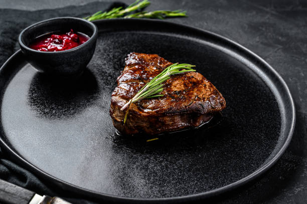 istock Grilled filet Mignon steak. Beef tenderloin. Black background. Top view 1193466781